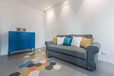 a living room with a couch and a blue dresser at Casa La Pomelia in Palermo