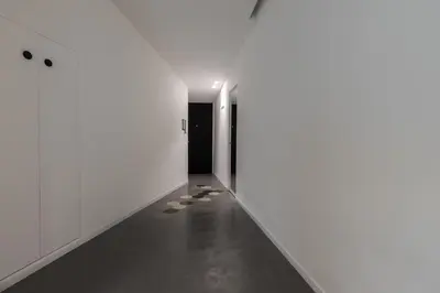 an empty hallway with white walls and concrete floors at Casa La Pomelia in Palermo
