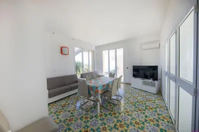 a living room with a couch and a table at Villa Francesca 30 Pax by Ville in Palermo in Casteldaccia