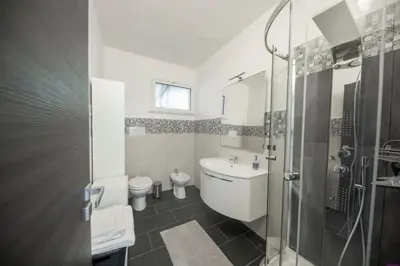 a bathroom with a toilet and a sink and a shower at Villa Francesca 30 Pax by Ville in Palermo in Casteldaccia