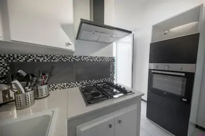 a kitchen with a stove and a counter top at Villa Francesca 30 Pax by Ville in Palermo in Casteldaccia