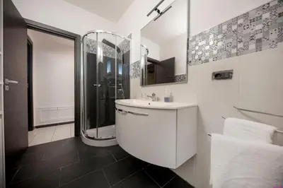a white bathroom with a shower and a sink at Appartamento 8 Pax in Villa Francesca by Ville in Palermo in Casteldaccia