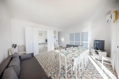 a living room with a table and a couch at Appartamento 8 Pax in Villa Francesca by Ville in Palermo in Casteldaccia