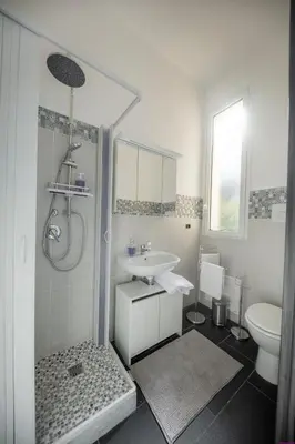 a white bathroom with a sink and a toilet at Appartamento 8 Pax in Villa Francesca by Ville in Palermo in Casteldaccia