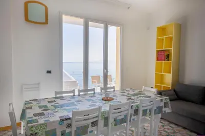 a dining room with a table and chairs and a window at Appartamento 16 Pax in Villa Francesca by Ville in Palermo in Casteldaccia