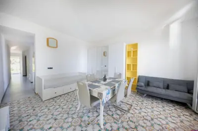 a living room with a table and a couch at Appartamento 23 Pax in Villa Francesca by Ville in Palermo in Casteldaccia