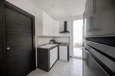 a kitchen with a sink and a stove at Appartamento 23 Pax in Villa Francesca by Ville in Palermo in Casteldaccia