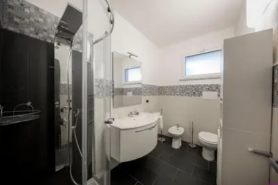 a bathroom with a sink and a toilet at Appartamento 23 Pax in Villa Francesca by Ville in Palermo in Casteldaccia