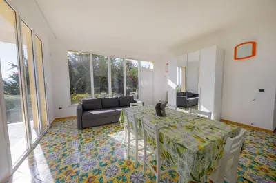 a living room with a table with a cat sitting on it at Appartamento 23 Pax in Villa Francesca by Ville in Palermo in Casteldaccia