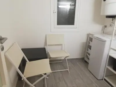 a kitchen with two chairs and a white refrigerator at Home 3L in Palermo
