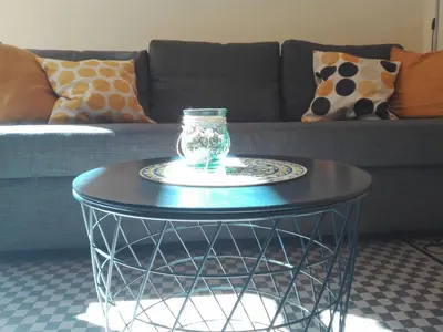 a glass jar on a table in front of a couch at 