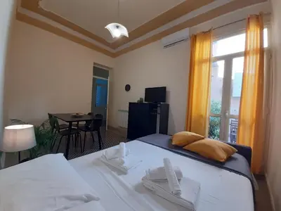a bedroom with a bed and a window and a table at 