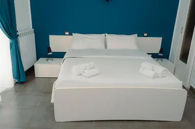 a large white bed with two towels on it at Rooms 19 - Rooms and Breakfast in Palermo