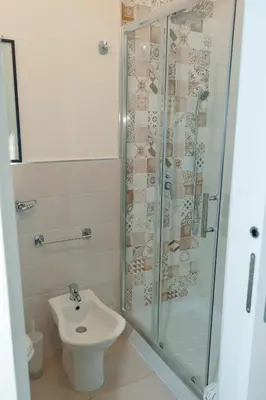 a bathroom with a shower and a toilet and a sink at Rooms 19 - Rooms and Breakfast in Palermo
