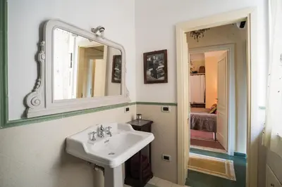 a bathroom with a sink and a mirror at Palermo Storica 