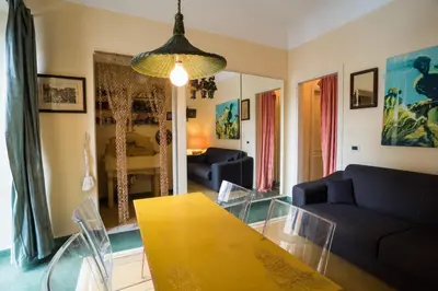 a living room with a table and chairs and a couch at Palermo Storica 