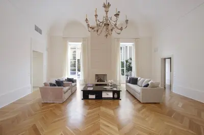 a living room with a chandelier and a wooden floor at La Kalsa Charming Maison in Palermo