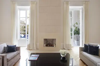a living room with a fireplace and a couch at La Kalsa Charming Maison in Palermo