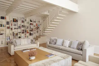 a living room with two couches and a staircase at La Kalsa Charming Maison in Palermo