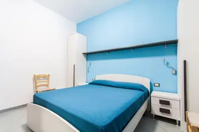 a bedroom with a bed with a blue head board at B&B 