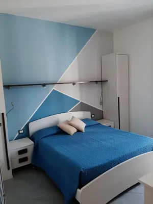 a bedroom with a blue and white bed with two pillows at B&B 