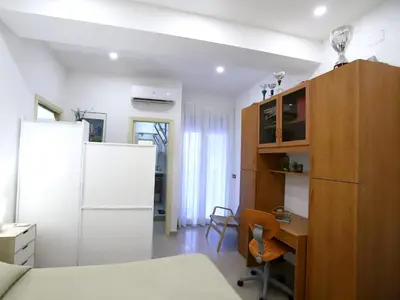 a kitchen with a refrigerator and a desk in a room at Plumeria/Libertà in Palermo