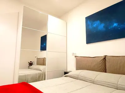 a bedroom with two beds and a large mirror at Betta splendens in Palermo
