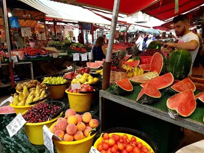 a market with many different fruits and vegetables in baskets at Hostel Centro BASEMENT in Palermo