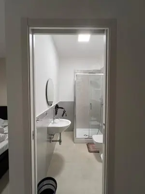 a bathroom with a shower and a sink at CESARE ROOMS in Palermo