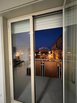 a view of a city at night from a window at CESARE ROOMS in Palermo