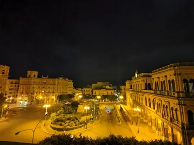 a city at night with street lights and buildings at CESARE ROOMS in Palermo
