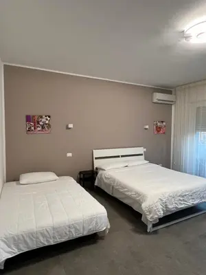 two beds in a room with two beds sidx sidx sidx at CESARE ROOMS in Palermo