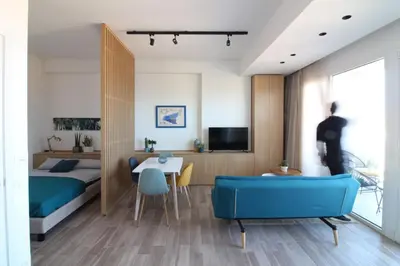 a bedroom with a bed and a blue couch at Seaview Apartments in Palermo