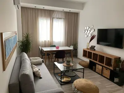 a living room with a couch and a table at Seaview Apartments in Palermo