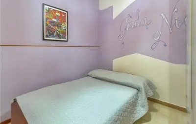 a bedroom with a bed in a room with purple walls at Beautiful Apartment In Palermo Pa in Sferracavallo