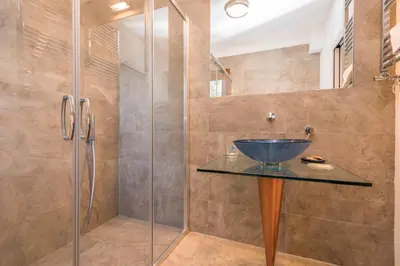 a bathroom with a glass shower with a bowl sink at B&B Le Dune - Self Check in in Lascari