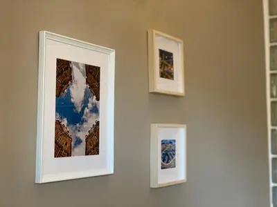 three framed pictures on the wall in a room at La Dimora della Cattedrale in Palermo