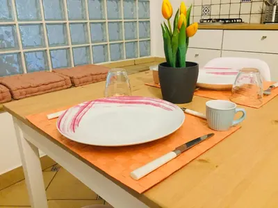 a table with two white plates on top of it at La Dimora della Cattedrale in Palermo