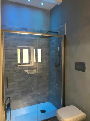 a bathroom with a glass shower with a toilet at Palazzo Liberty in Monreale