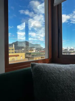 a bedroom with a window with a view of a city at SuperAttico Bella Bellù in Palermo