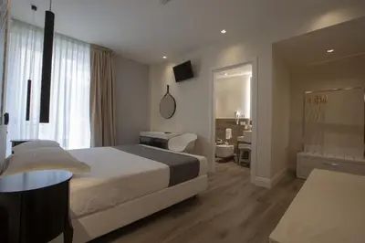 a hotel room with a bed and a desk at Luxmarì Hotel & Spa in Castellammare del Golfo