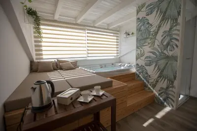 a room with a bed and a bath tub at Luxmarì Hotel & Spa in Castellammare del Golfo
