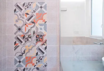 a bathroom with a shower with a mosaic tile wall at Donna Isa B&B in Palermo