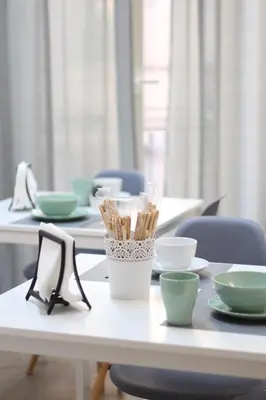 a table with plates and chopsticks on top at Solli Rooms in Palermo