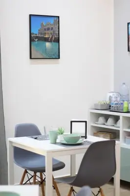 a white table and chairs in a room at Solli Rooms in Palermo