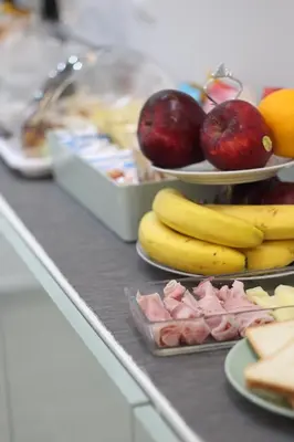a buffet with bananas apples and other fruits on plates at Solli Rooms in Palermo
