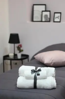 a pile of towels sitting on top of a bed at Solli Rooms in Palermo