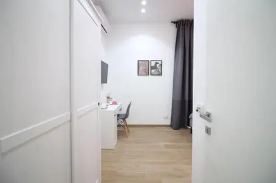 a hallway with a desk and a table in a room at Solli Rooms in Palermo