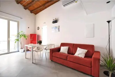 a living room with a red couch and a table at San Francesco Rooms and Apartment with Terrace in Palermo Locazione Turistica in Palermo