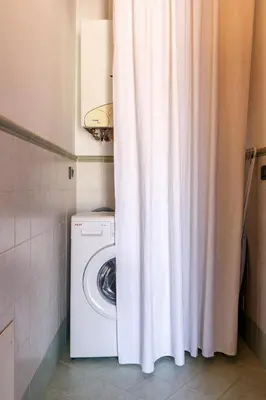 a washing machine in a bathroom with a shower curtain at Palazzo Edy&Stef 1 in Palermo